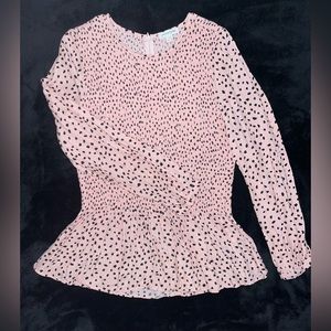Pretty dot patterned top. Fitted through the top, flared at the waist.